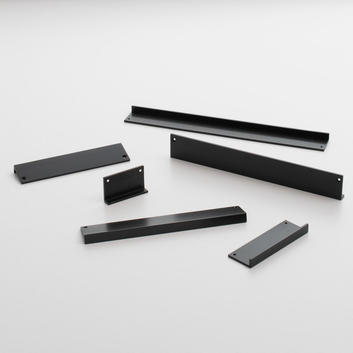Angled view of Ledge Pull showcasing multiple black pull components with mounting holes on a white background