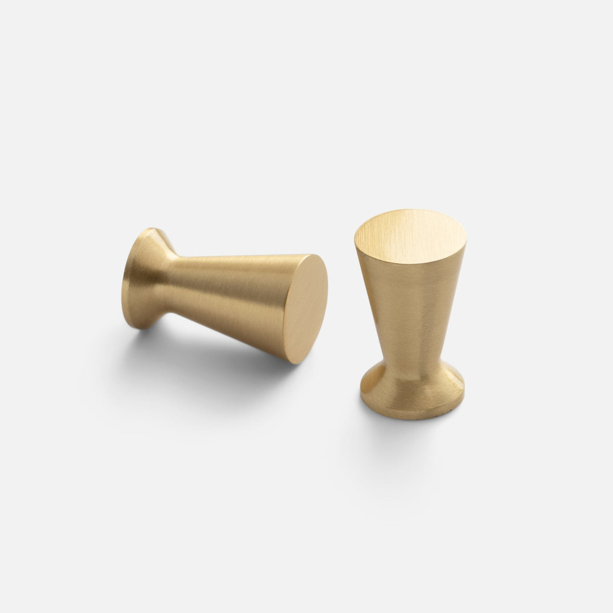 Angled view of Radcliffe Knob showcasing its tapered solid brass design with a light gray background