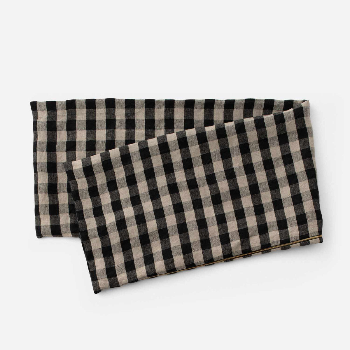 Angled view of Linen Check Throw Pillow showcasing its black and natural check pattern on a white background