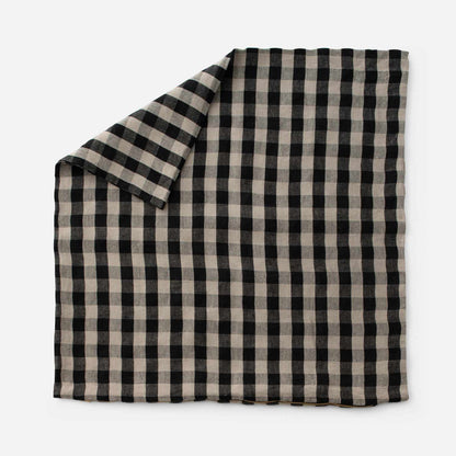 Top view of Linen Check Throw Pillow showcasing its black and natural check pattern on a white background