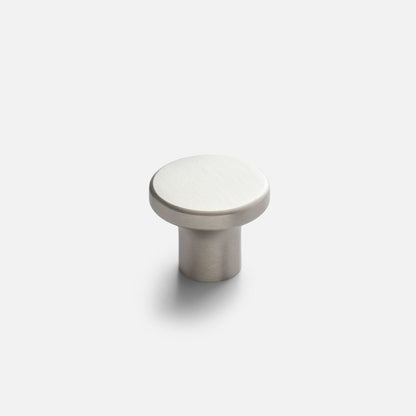 Angled view of the Roland cabinet knob showcasing a round brushed satin nickel face and cylindrical base with a white background