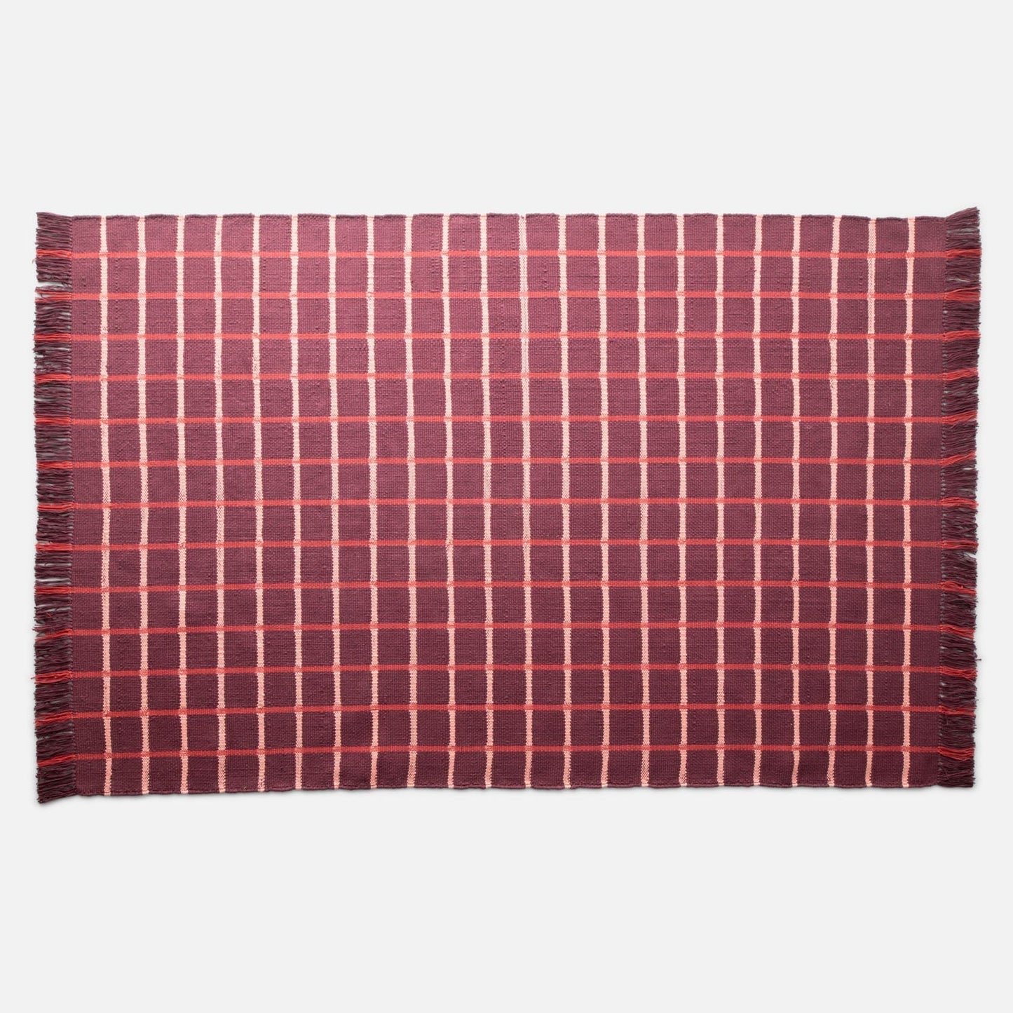 Top-down view of Cotton Grid Flatweave Rug showcasing large contrasting grid pattern and fringed edges on white background