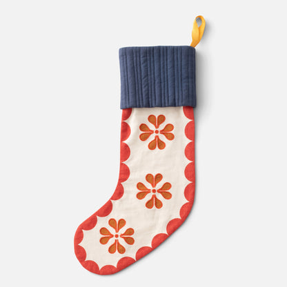 Front view of Swiss Scallop Stocking showcasing red scalloped trim and floral pattern with a light gray background