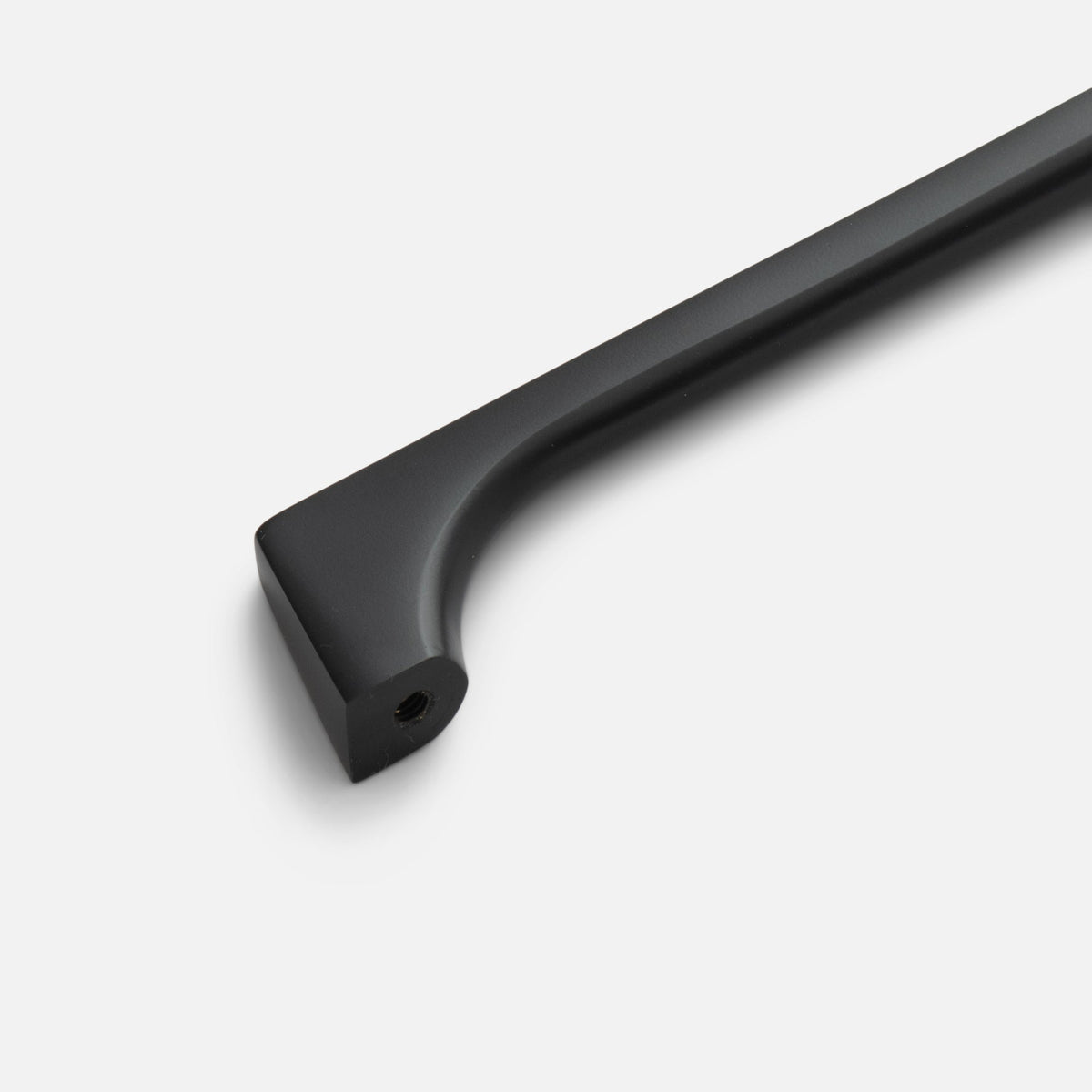 Close-up of black Truss Pull showcasing its curved bar and threaded mounting hole on a white background