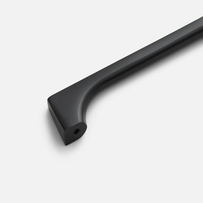 Close-up of black Truss Pull showcasing its curved bar and threaded mounting hole on a white background
