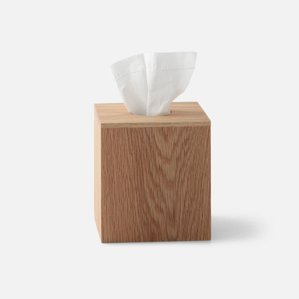 Front three-quarter view of Oak Tissue Box showcasing natural oak wood and tissue opening with a white background