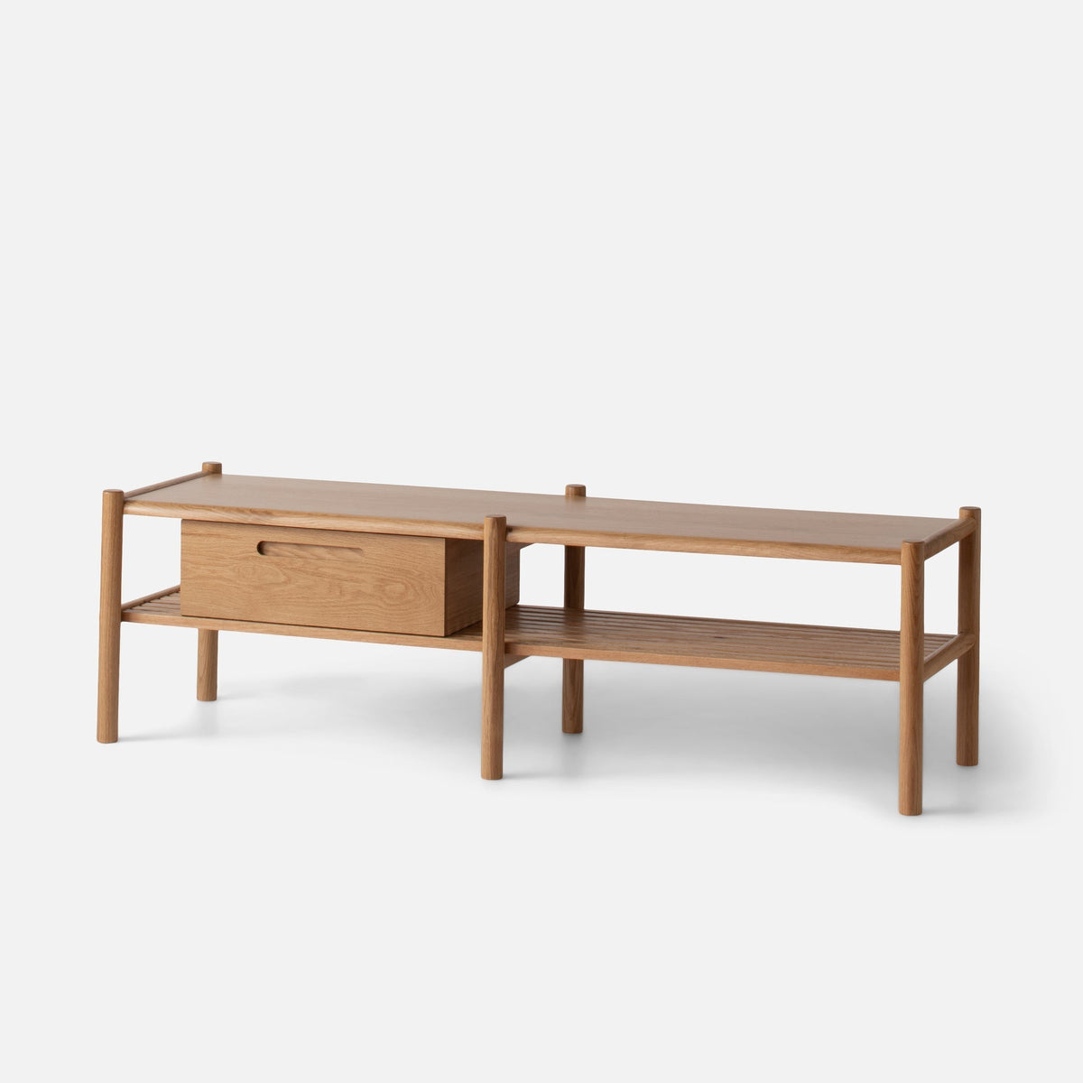 Three-quarter view of Nora Storage Bench showing rounded oak legs, lower shelf, and removable wooden storage box on light gray
