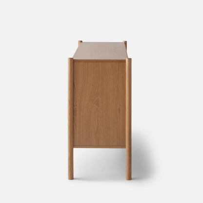 Rear view of Nora 6-Drawer Dresser showcasing oak wood grain and rounded posts against a white background