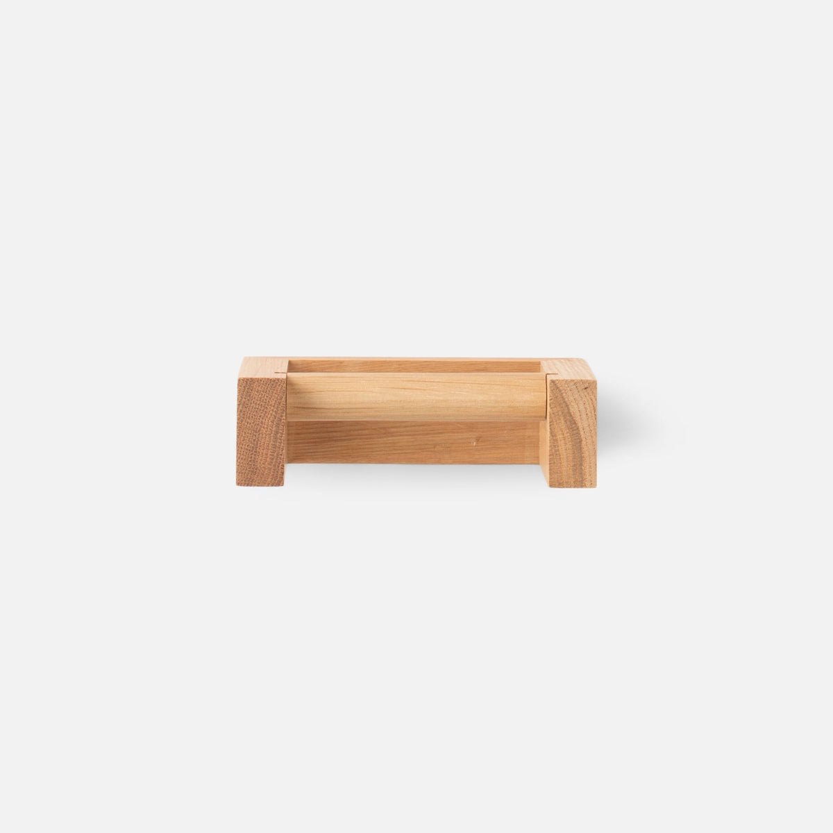 Front view of oak tissue roll holder showcasing natural oak wood and smooth finish against a light background