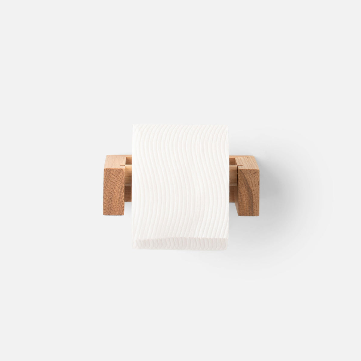 Front view of Oak Tissue Roll Holder showcasing natural oak wood and a white tissue roll on a light background