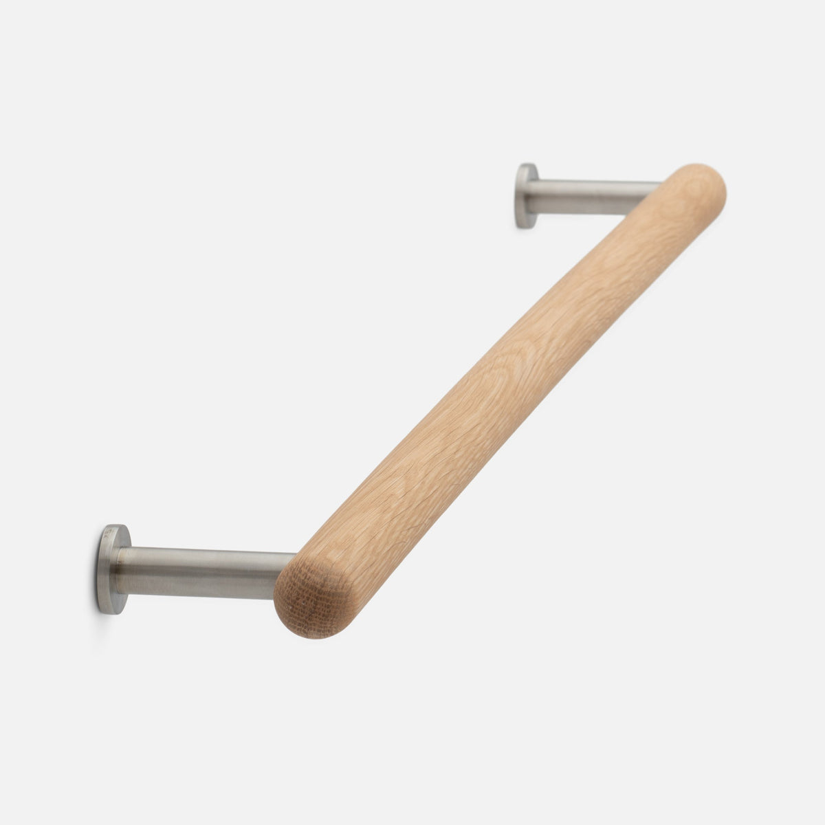 Angled view of Oak Towel Bar showcasing its oak wood bar and metal wall mounts against a light background