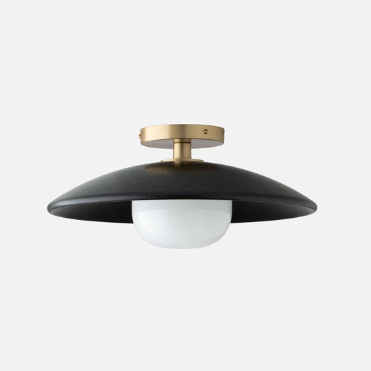 Front view of Atwood Wood Flush Mount 16 inch showcasing a curved oak shade, opal glass diffuser, and brass fixture