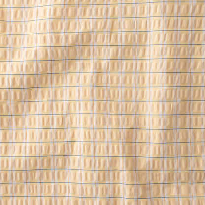 Close-up of Seersucker Check Duvet showcasing yellow and natural cotton seersucker check texture
