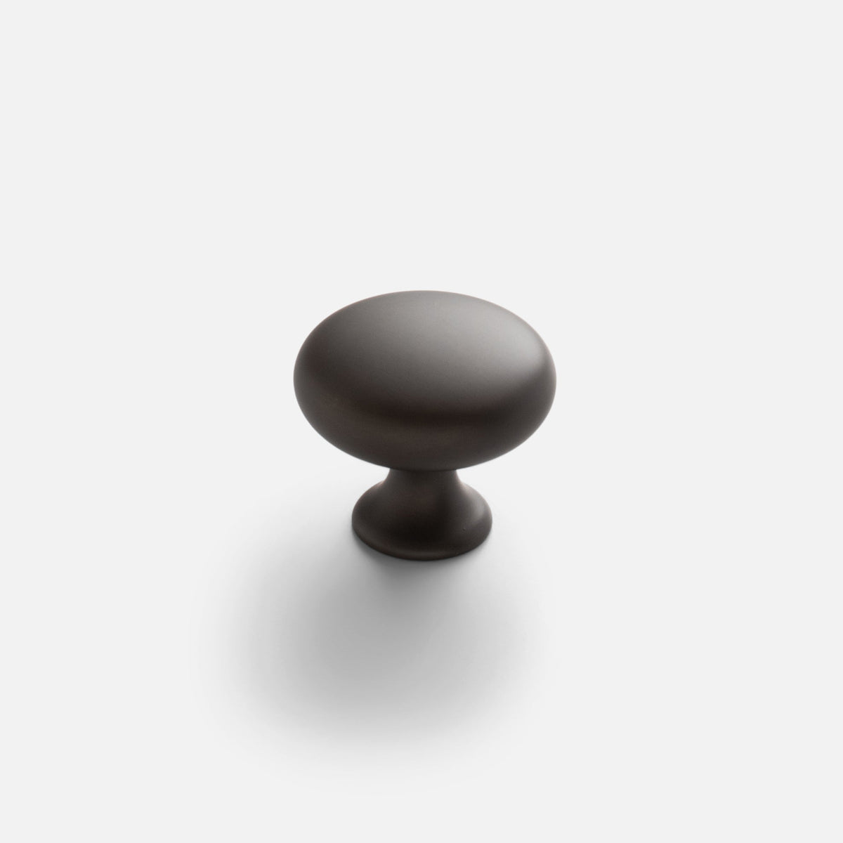 Front view of Somerset Knob showcasing its egg-shaped solid brass design on a light background