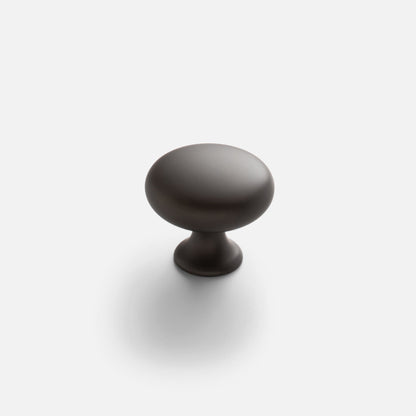 Front view of Somerset Knob showcasing its egg-shaped solid brass design on a light background