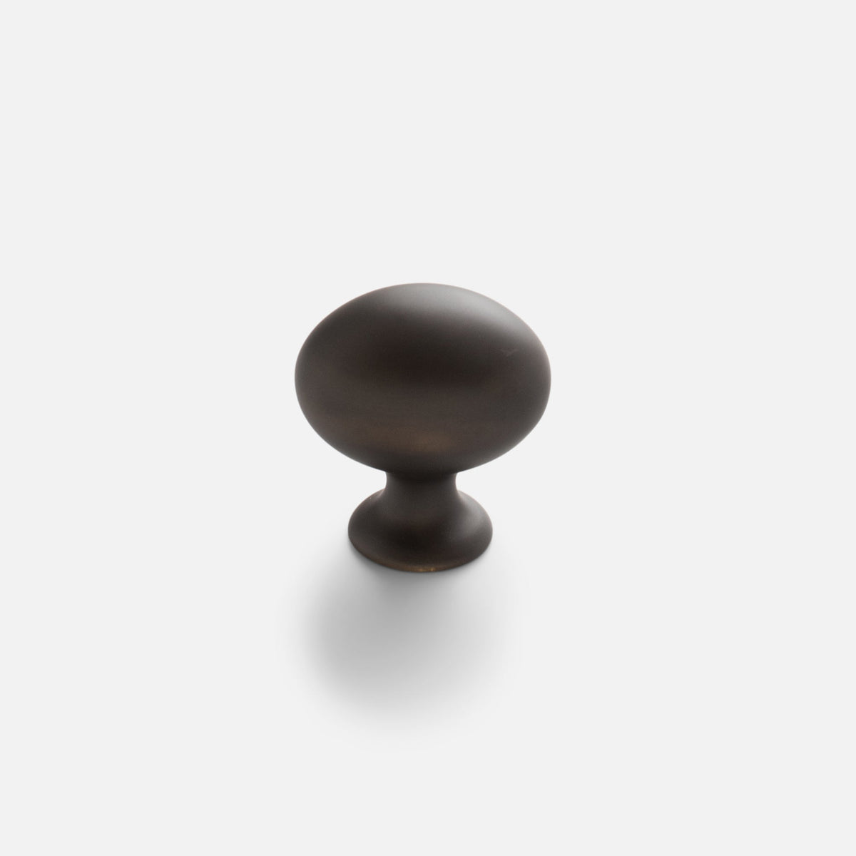 Front view of Somerset Knob showcasing its egg-shaped solid brass design against a white background
