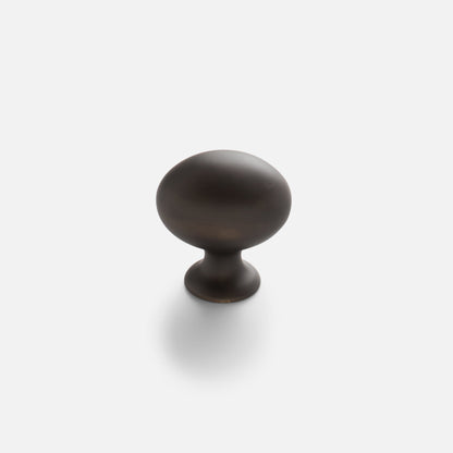 Front view of Somerset Knob showcasing its egg-shaped solid brass design against a white background