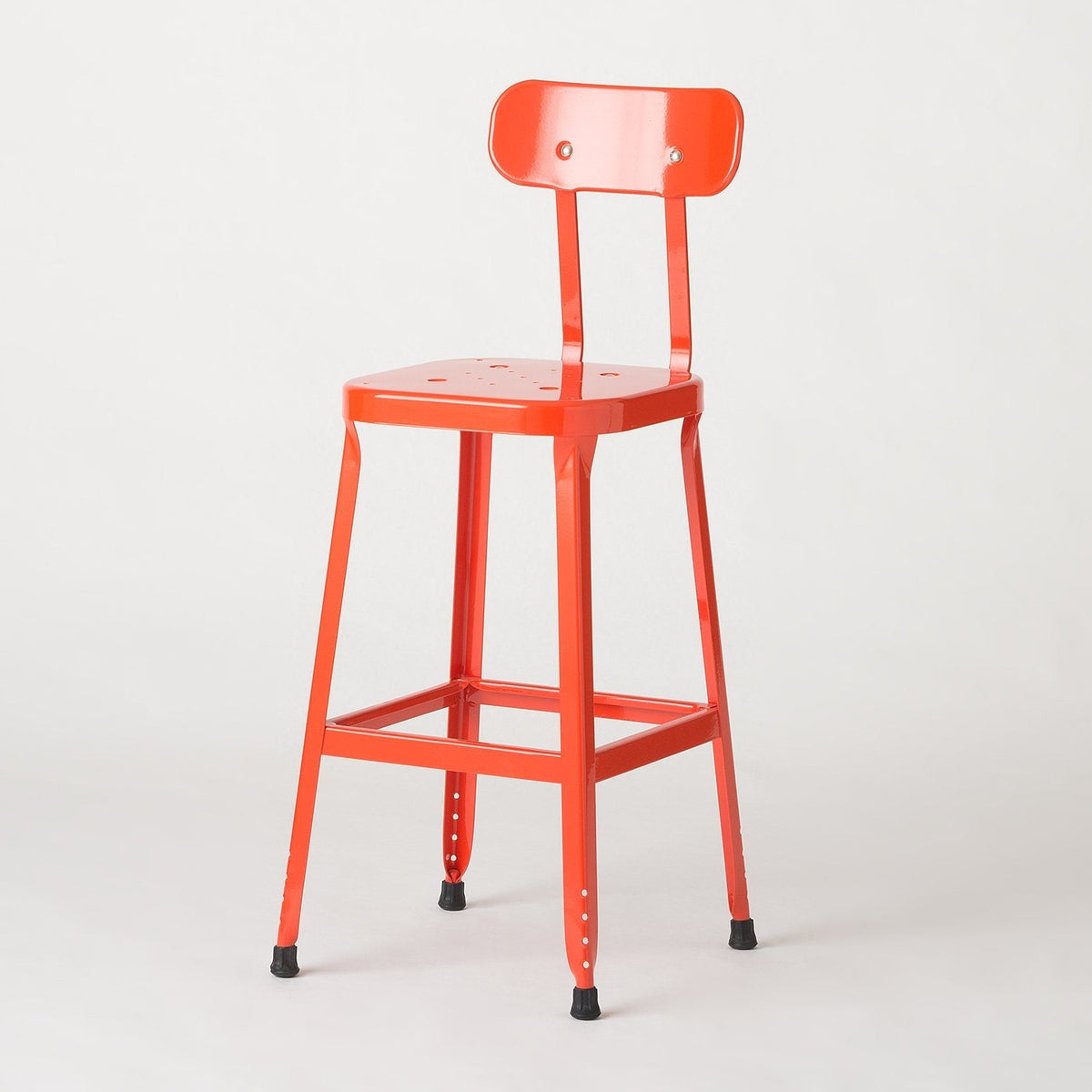 Three-quarter view of Schoolhouse Utility Stool 26 inch with backrest, footrest, and rubber feet on white background