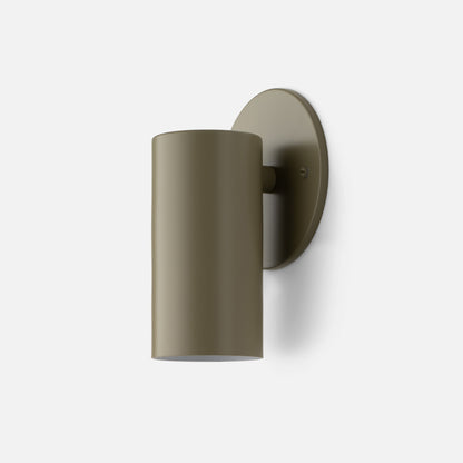 Front three-quarter view of Eduard Wall Sconce showcasing its Lichen-Satin closed cylindrical shade and round wall plate with a white background