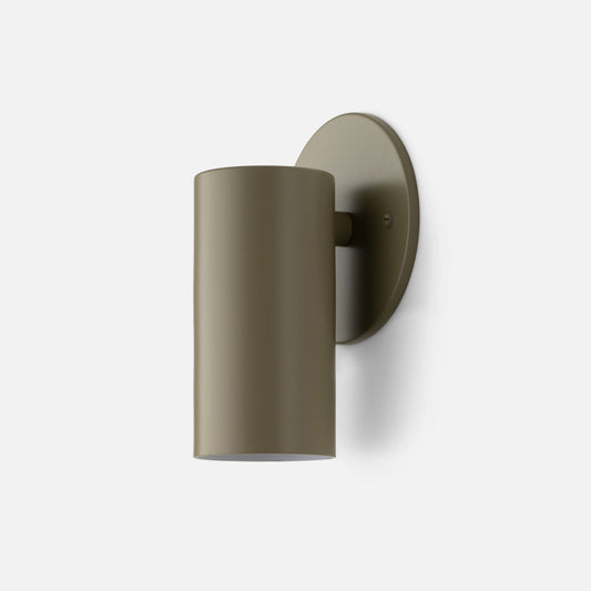 Front three-quarter view of Eduard Wall Sconce showcasing its Lichen-Satin closed cylindrical shade and round wall plate with a white background