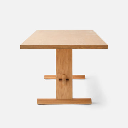 Front view of Darrow Dining Table showing solid oak frame and contrasting walnut stretcher on a white background