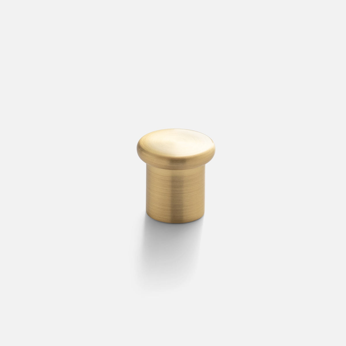 Front view of Remy Knob showcasing solid brass construction and soft curves with a light gray background