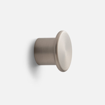 Close-up angled view of Remy Single Hook showcasing its cylindrical form with a plain light background
