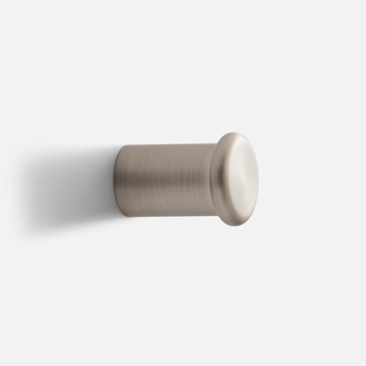 Close-up side view of Remy Single Hook showcasing its cylindrical form and rounded end cap against a white background