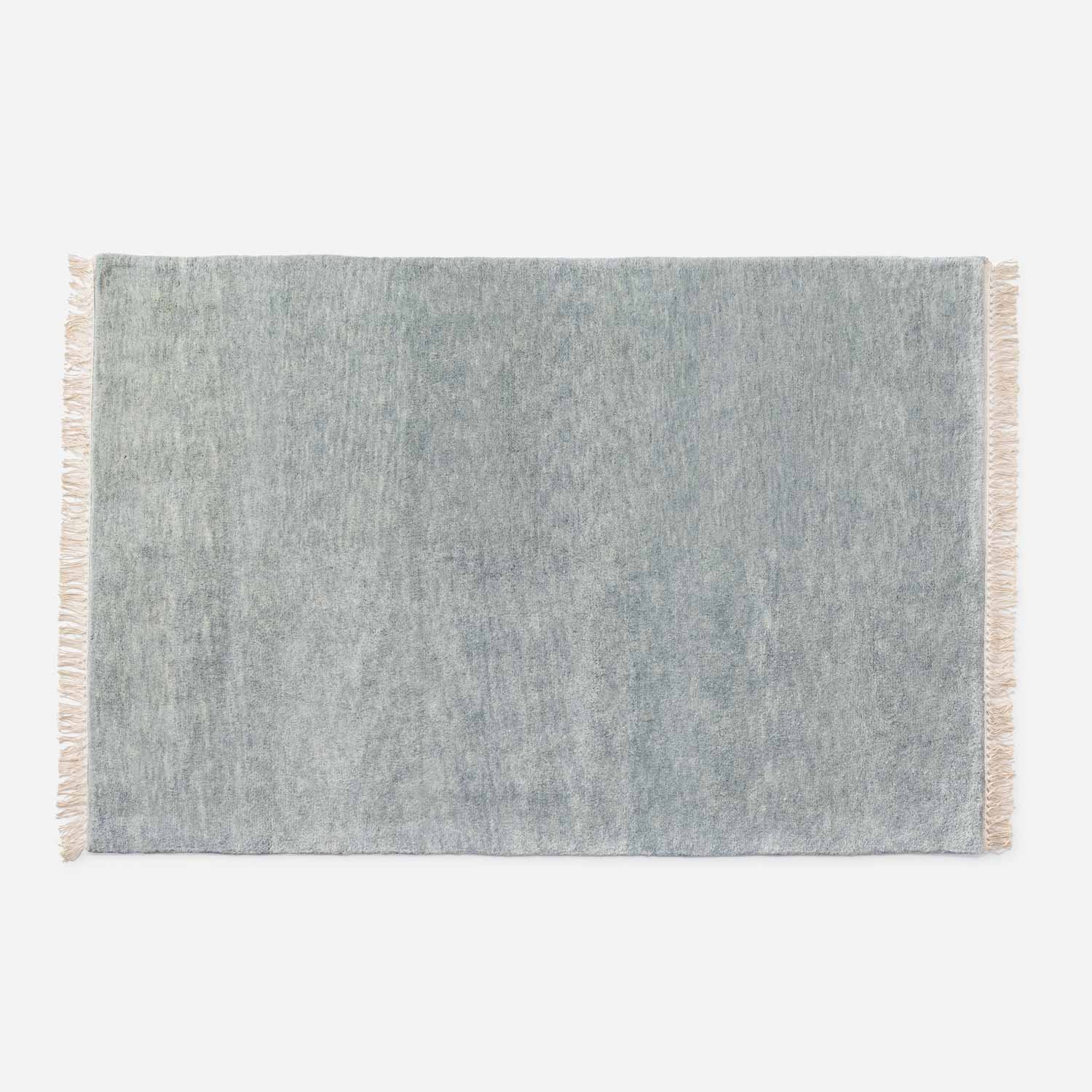 Top-down view of Mesa Wool Rug showcasing hand-loomed 100 percent New Zealand wool pile and fringe on a white background