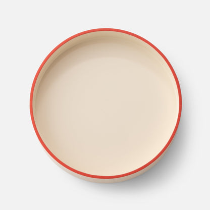 Top view of Clare V Sonia Tray showcasing its red rim and shallow round shape on a white background