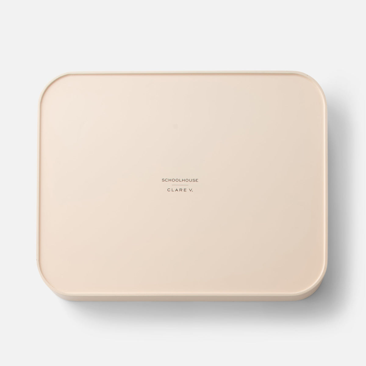 Top view of Clare V Sonia Tray showcasing rounded corners and raised rim on a white background