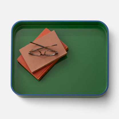Top view of Clare V Sonia Tray showcasing its green surface and blue rim with books and eyeglasses on a white background