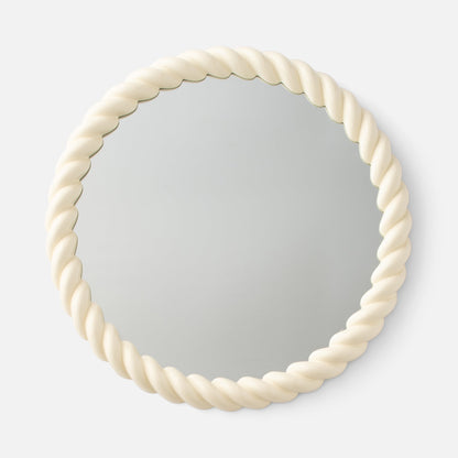 Angled view of Fernand Mirror showcasing its chunky twisted Ecru-Gloss frame with a plain white background