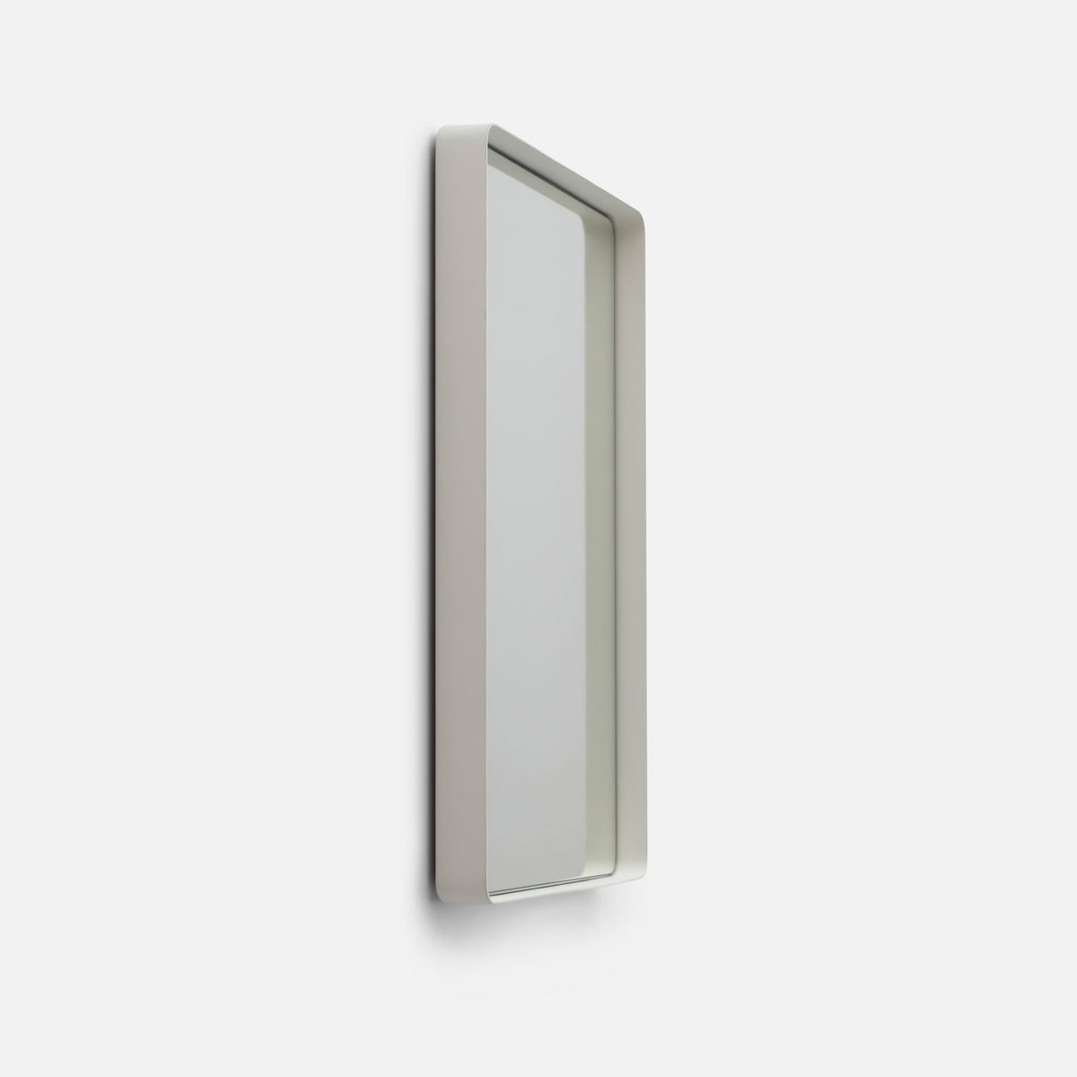 Side view of Leo Mirror showcasing its slim white rectangular frame with a light background