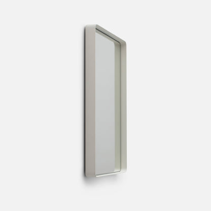 Side view of Leo Mirror showcasing its slim white rectangular frame with a light background