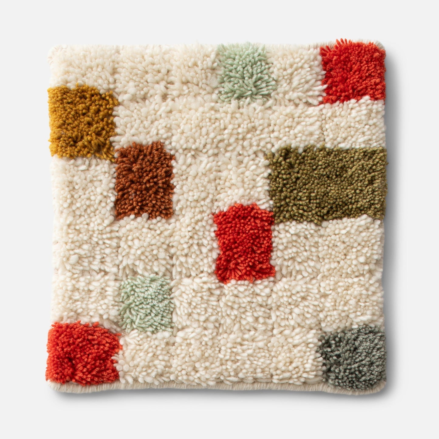 Close-up of Pixel Handloom Shag Rug showing high pile wool texture and multicolored geometric tufted squares on white background