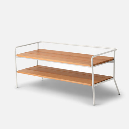 Front three-quarter view of Ronda Entryway Bench showcasing teak slat shelves and white steel frame on a light gray background