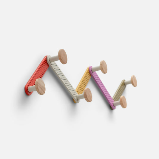 Angled view of Tula Hook showcasing perforated multicolor metal and natural wood finials with a white background