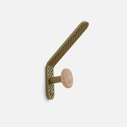 Angled view of Tula Hook showcasing perforated olive satin metal and natural wood finial with a light background