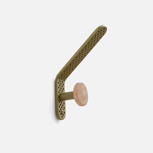 Angled view of Tula Hook showcasing perforated olive satin metal and natural wood finial with a light background