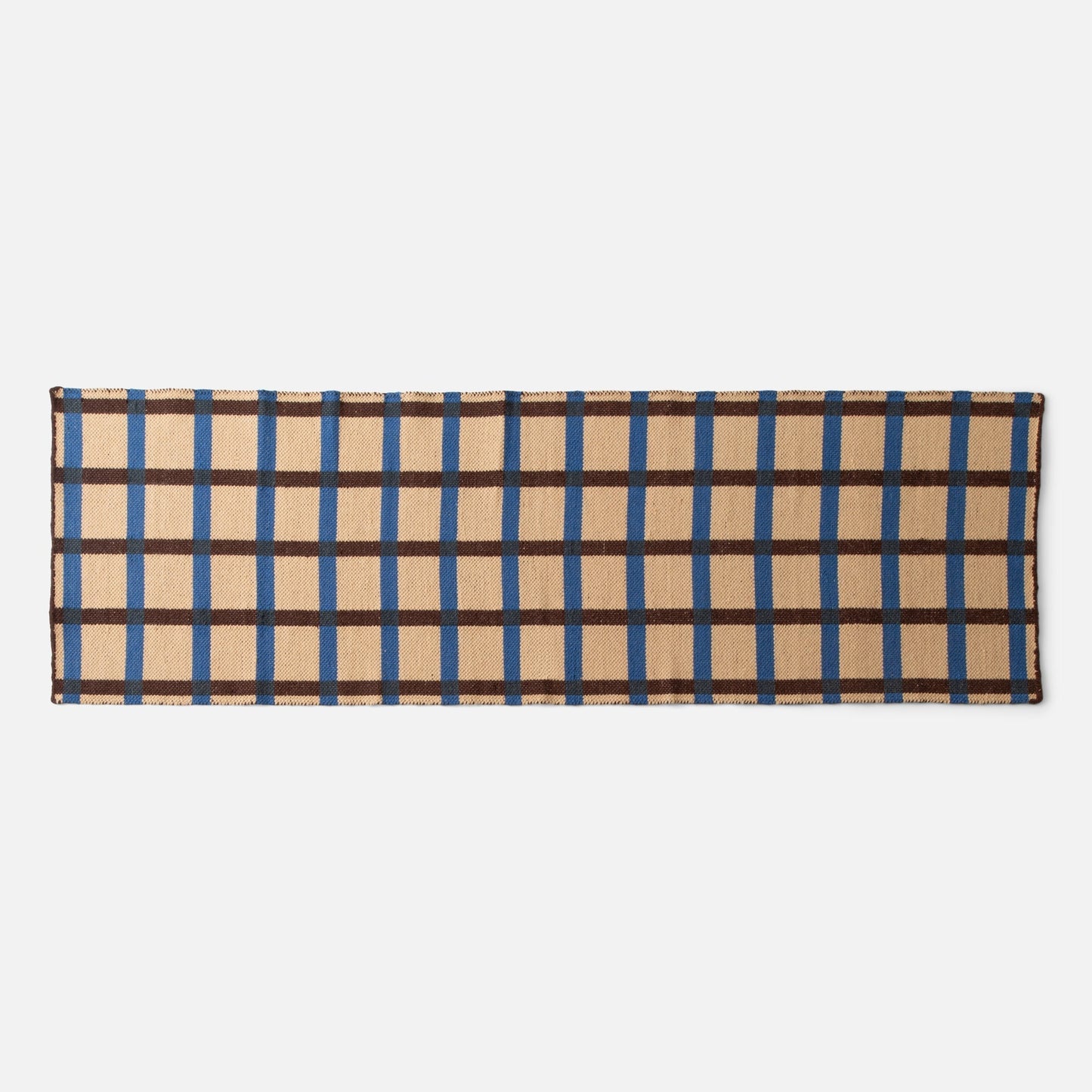 Top edge of Plaid Wool Reversible Rug showing woven beige plaid with blue and brown stripes on white background