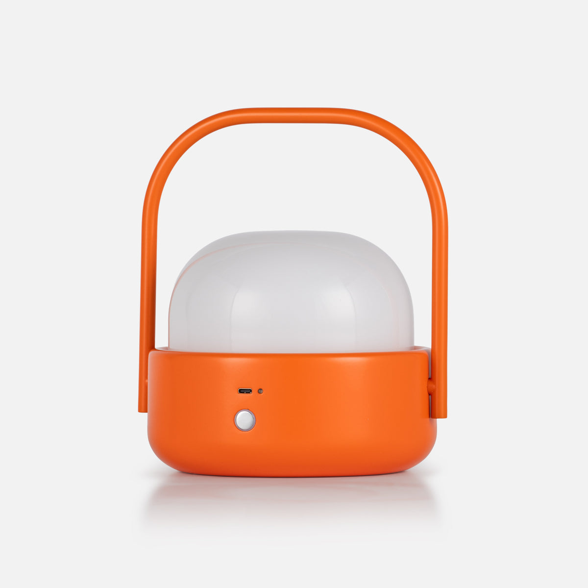 Front view of Cooper Table Lamp showcasing orange housing, carry handle, and white diffuser against a light background