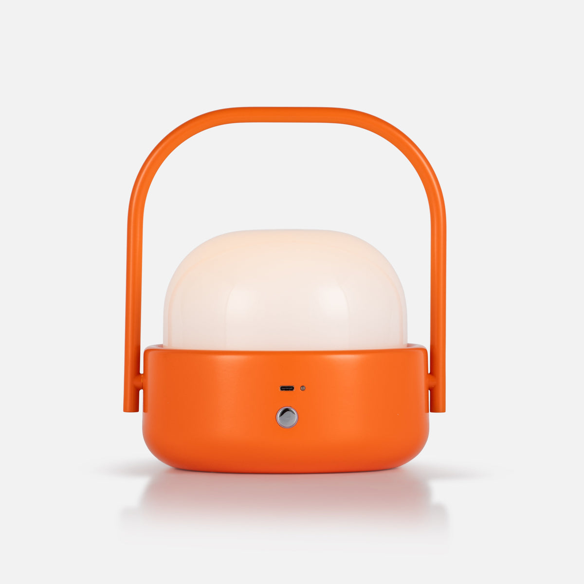 Front view of Cooper Table Lamp showcasing orange finish, domed shade, and carry handle on a white background