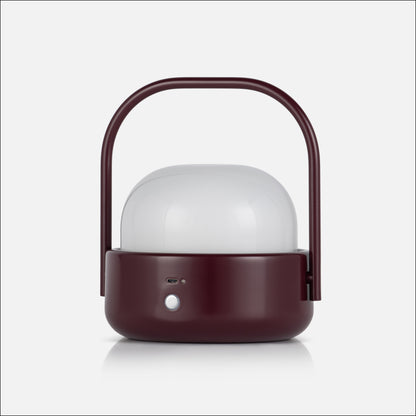 Front view of Cooper table lamp showcasing burgundy finish, white diffuser, curved handle, and front controls on a white background