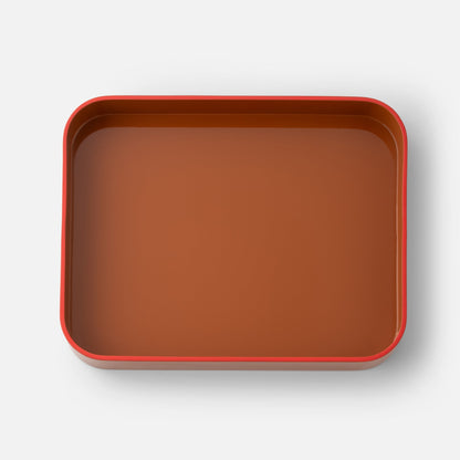 Top view of Clare V Sonia Tray showcasing a red rim and brown interior on a white background