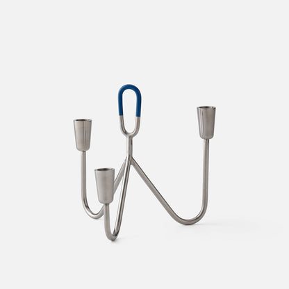 Front view of Loop Candelabra showcasing chrome finish, three candle holders, and blue loop accent with a white background