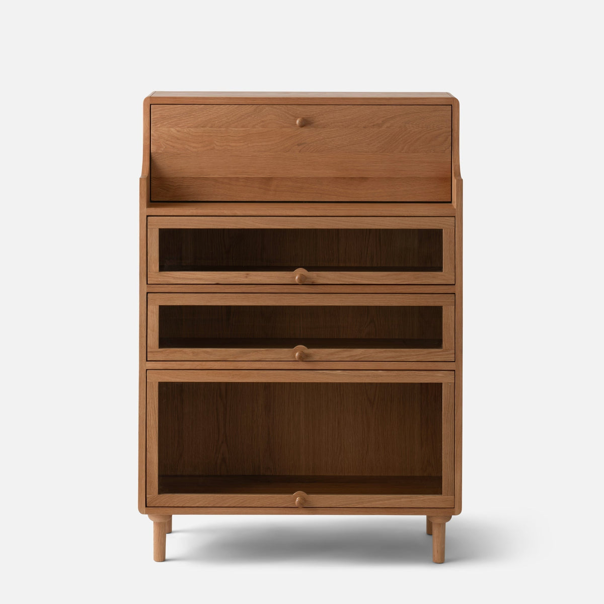 Front view of Peggy Cabinet showcasing four stacked drawers and tapered legs against a white background