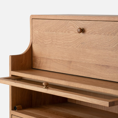 Close-up front view of Peggy Cabinet showcasing wood grain, rounded edges, and open drawers against a white background