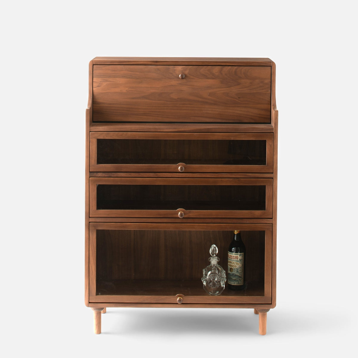 Front view of Peggy Cabinet showcasing three glass-front storage compartments and tapered legs with a white background