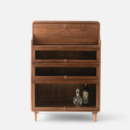 Front view of Peggy Cabinet showcasing three glass-front storage compartments and tapered legs with a white background